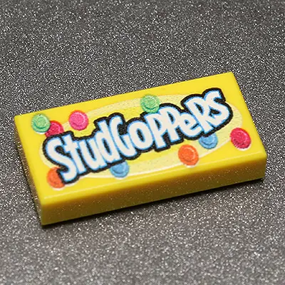 Custom printed LEGO Studgoppers 1x2 tile by B3 Customs featuring unique design on a white background.