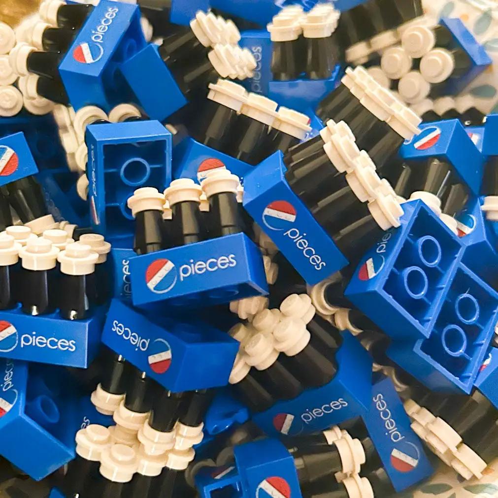 Six LEGO builds resembling Pepsi soda cans in a 6-pack, created by B3 Customs, showcasing colorful brick craftsmanship.