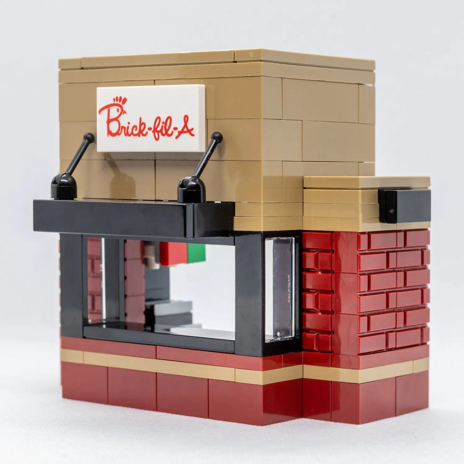 LEGO Chick-Fil-A food stand with B3 Customs employee minifigure, detailed city building scene with colorful brick design.