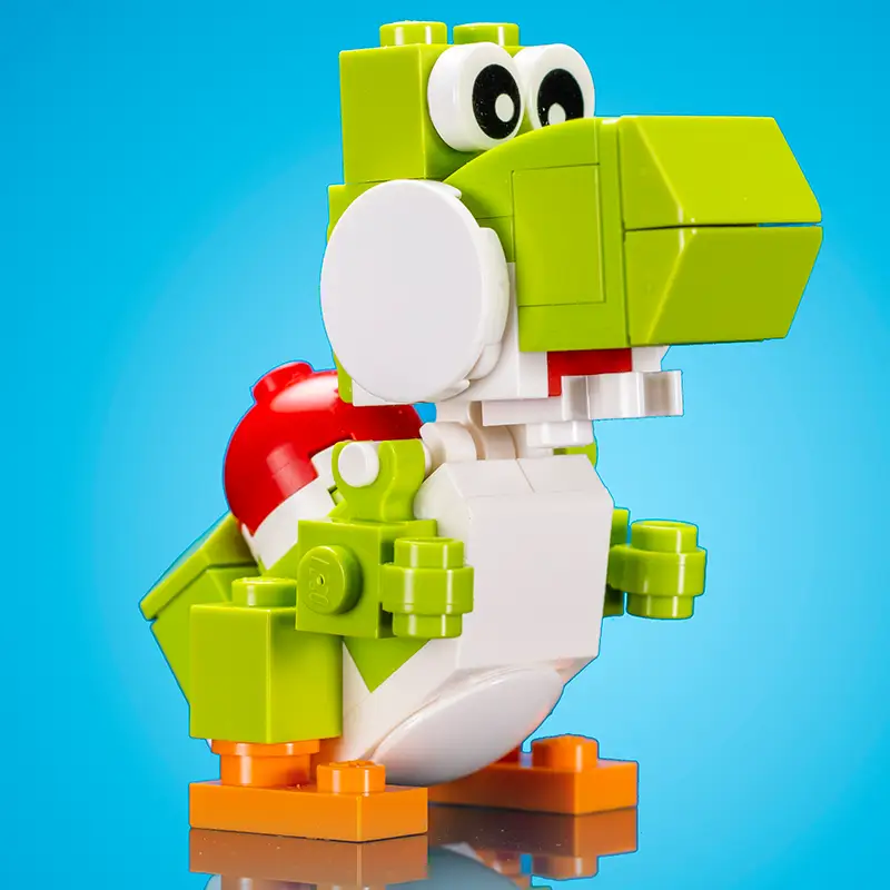 Colorful LEGO-friendly green dinosaur toy modeled after Yoshi, made by B3 Customs with detailed brick construction.