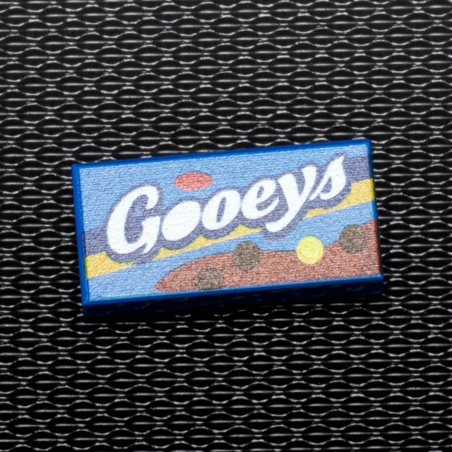 Colorful Gooeys B3 Customs printed 1x2 tile featuring a fun candy design, perfect for LEGO or custom building projects.