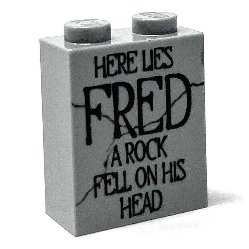 Here Lies Fred Halloween tombstone made of 1x2x2 brick by B3 Customs, featuring a humorous skull and crossbones design.
