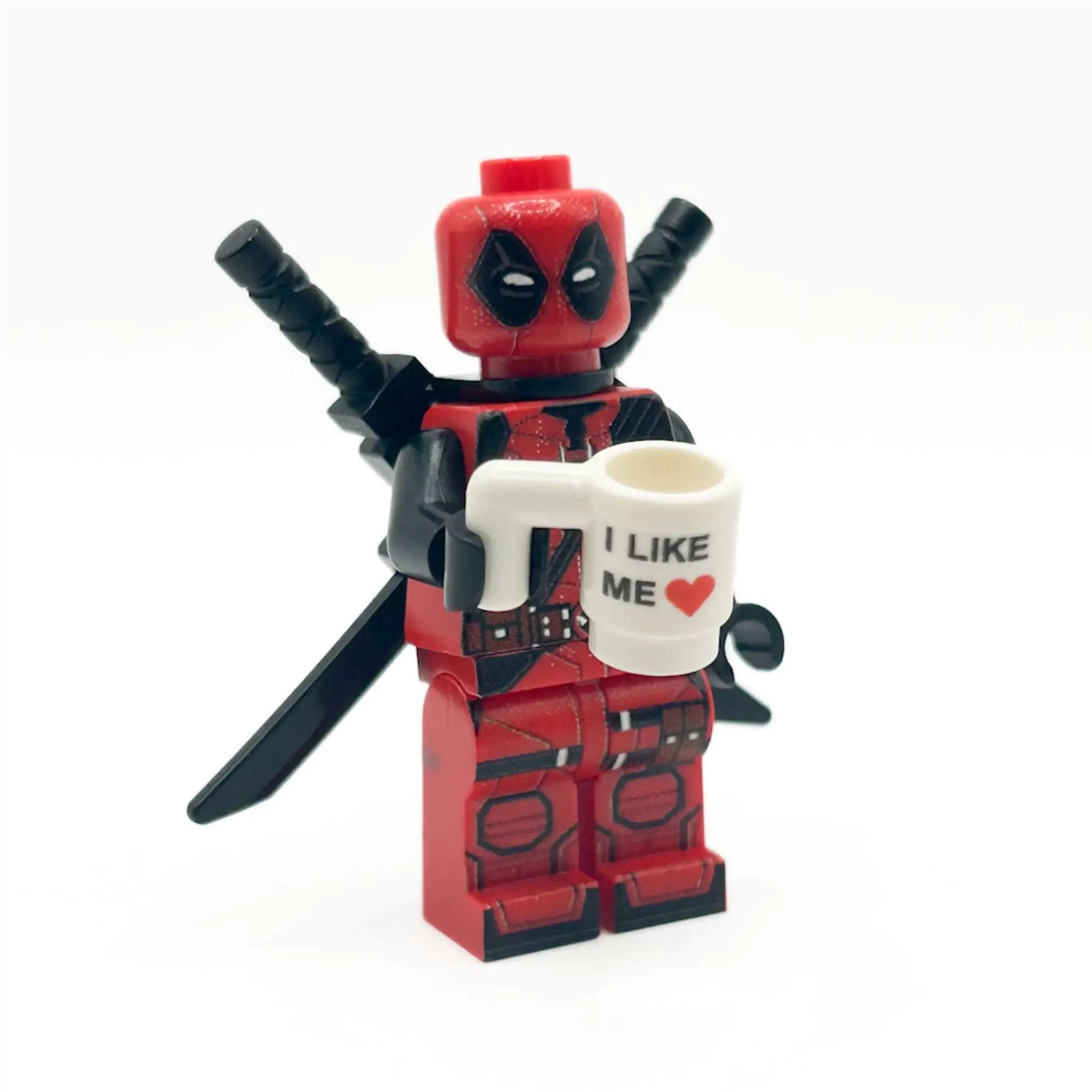B3 Customs I Like ME Heart Mug for Minifigs from Deadpool 3, featuring a heart design and miniature figure display.