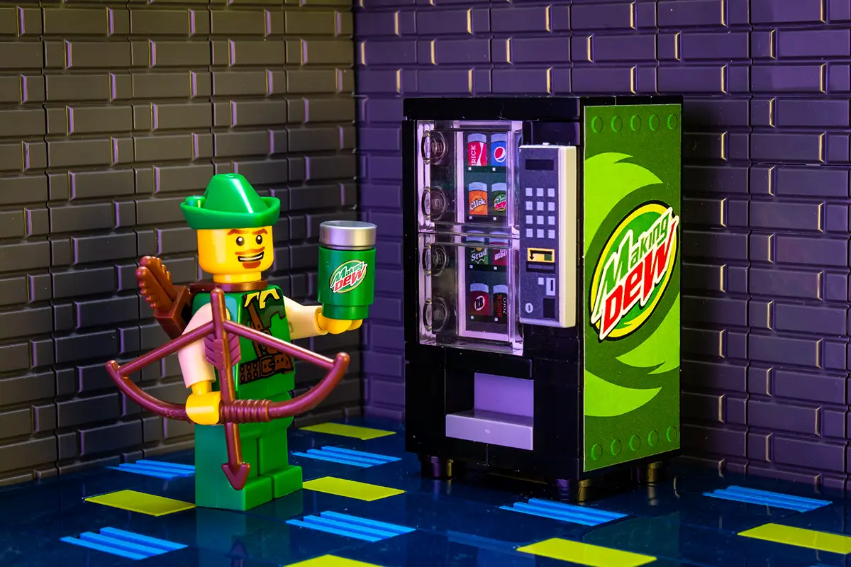 Making Dew soda vending machine built with LEGO parts by B3 Customs, featuring colorful LEGO bricks and detailed vending machine design.