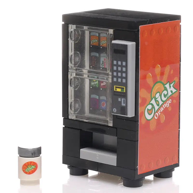 White can of B3 Customs Orange Click soda from the vending machine, showing vibrant orange branding and product label.