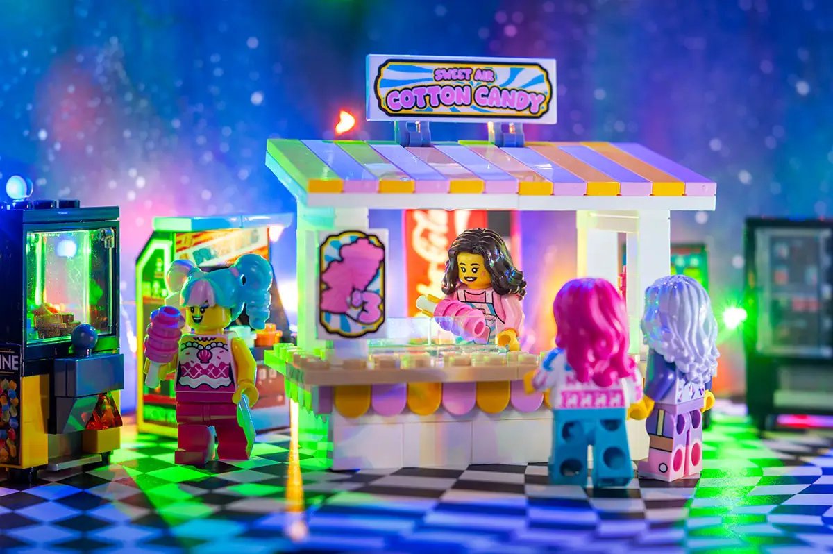 Lego cotton candy stand with B3 Customs employee minifigure, colorful carnival-themed sweet air cotton candy display.