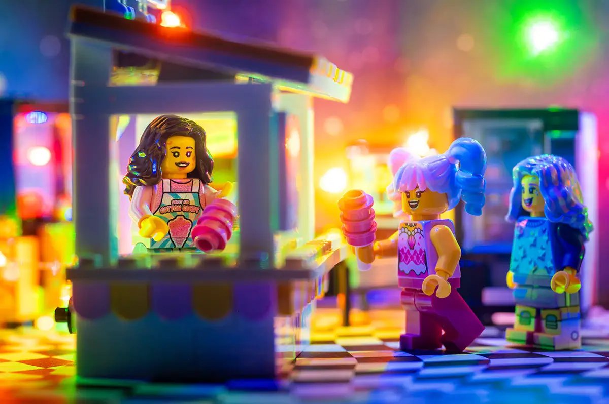 Custom LEGO cotton candy stand with employee minifigure, colorful carnival-themed Sweet Air Cotton Candy Stand by B3 Customs.