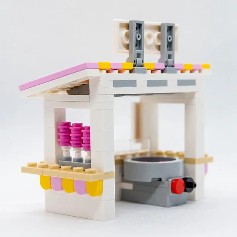 Lego-style Sweet Air Cotton Candy Stand with B3 Customs employee minifigure, colorful cotton candy display and vibrant setup.