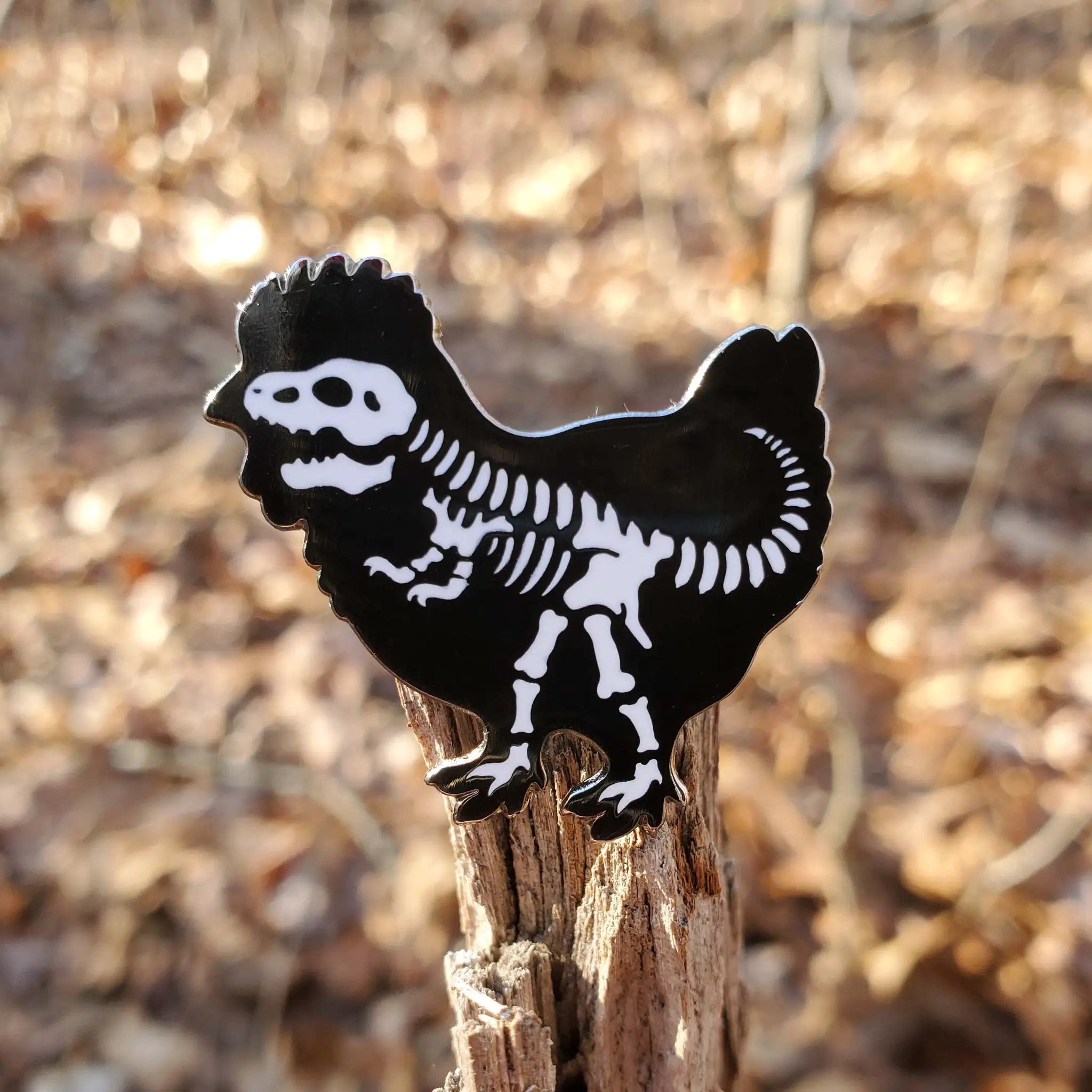 Kolorspun chicken dinosaur pin featuring a colorful cartoon dinosaur design, perfect for accessorizing clothing or bags.