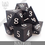 Blackwoods wood dice set in gift box from DNDDICE.COM, featuring handcrafted wooden gaming dice for tabletop games.