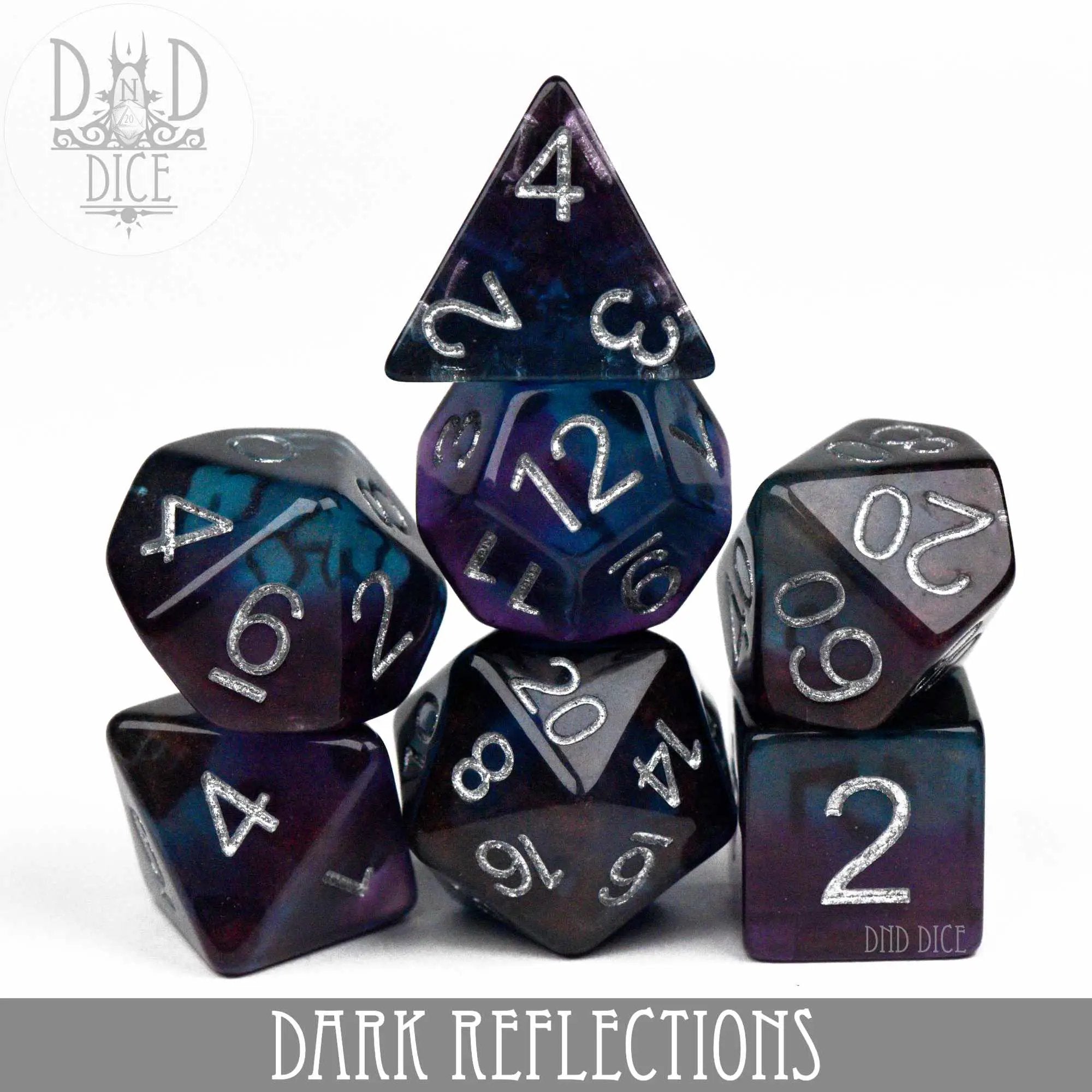 Dark Reflections dice set from DNDDICE.COM featuring a variety of multi-colored polyhedral dice on a dark background.