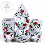 Metal dice set featuring an enchanted rose design, perfect for tabletop games and role-playing, from DNDDICE.COM.
