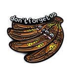 Kolorspun Don't Forget Us Banana golf ball marker with colorful design, used for marking golf balls on the green.