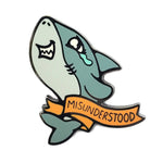 Kolorspun Misunderstood Shark pin featuring a detailed, colorful shark design on a pin accessory.
