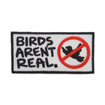 Birds Aren't Real patch by Kolorspun featuring colorful embroidered design on fabric patch.
