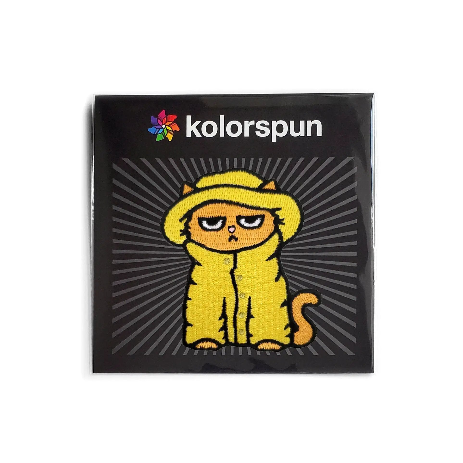 Kolorspun Grumpy Raincoat Cat Patch sewn onto a fabric, featuring a humorous cat design with a raincoat motif.