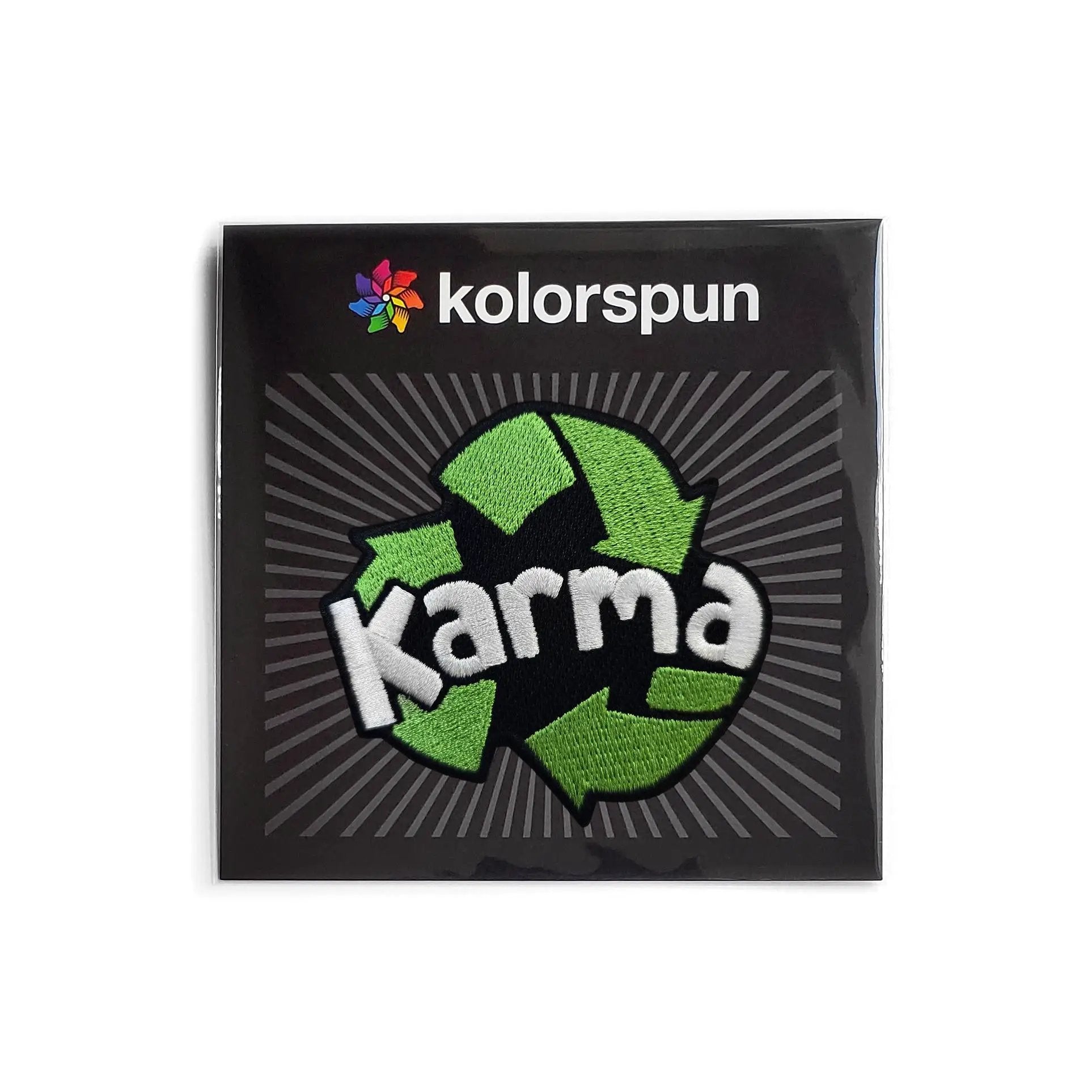 Kolorspun Karma Recycling Patch sewn onto fabric, featuring eco-friendly design and vibrant colors for sustainable fashion use.