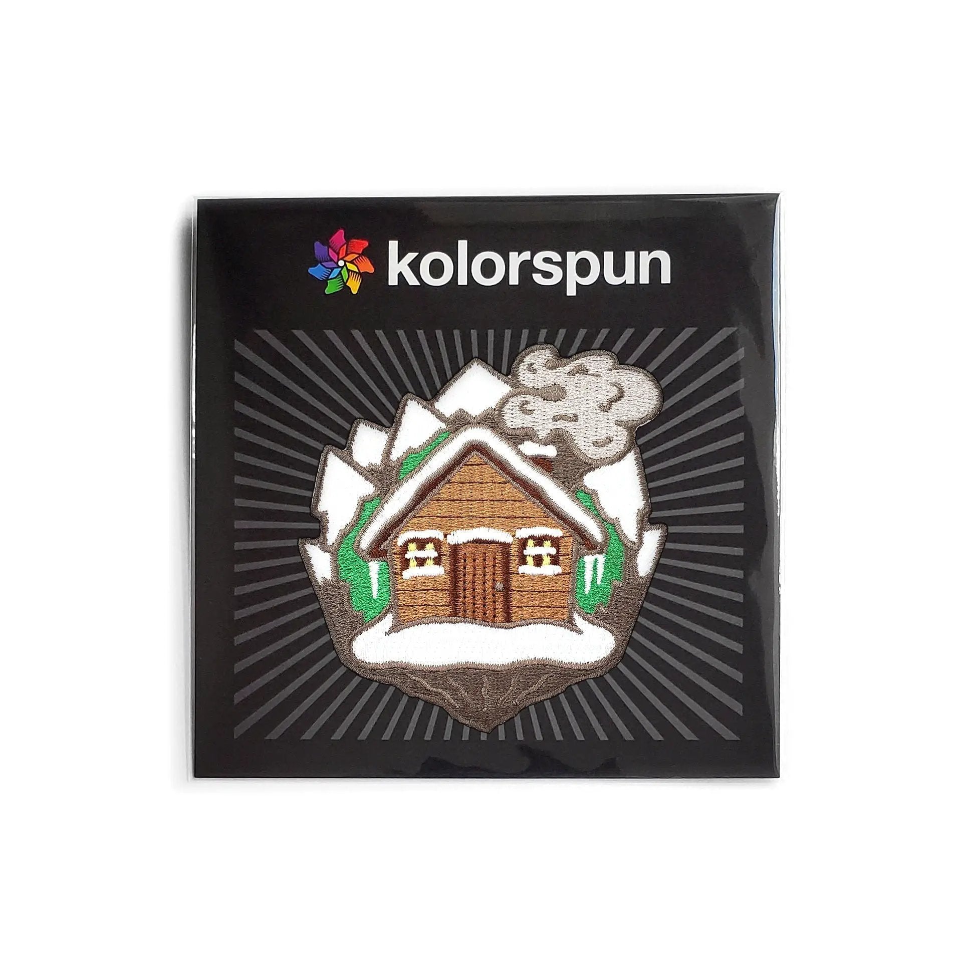 Kolorspun Log Cabin Patch featuring a colorful patch with a log cabin design, ideal for sewing or decorating craft projects.