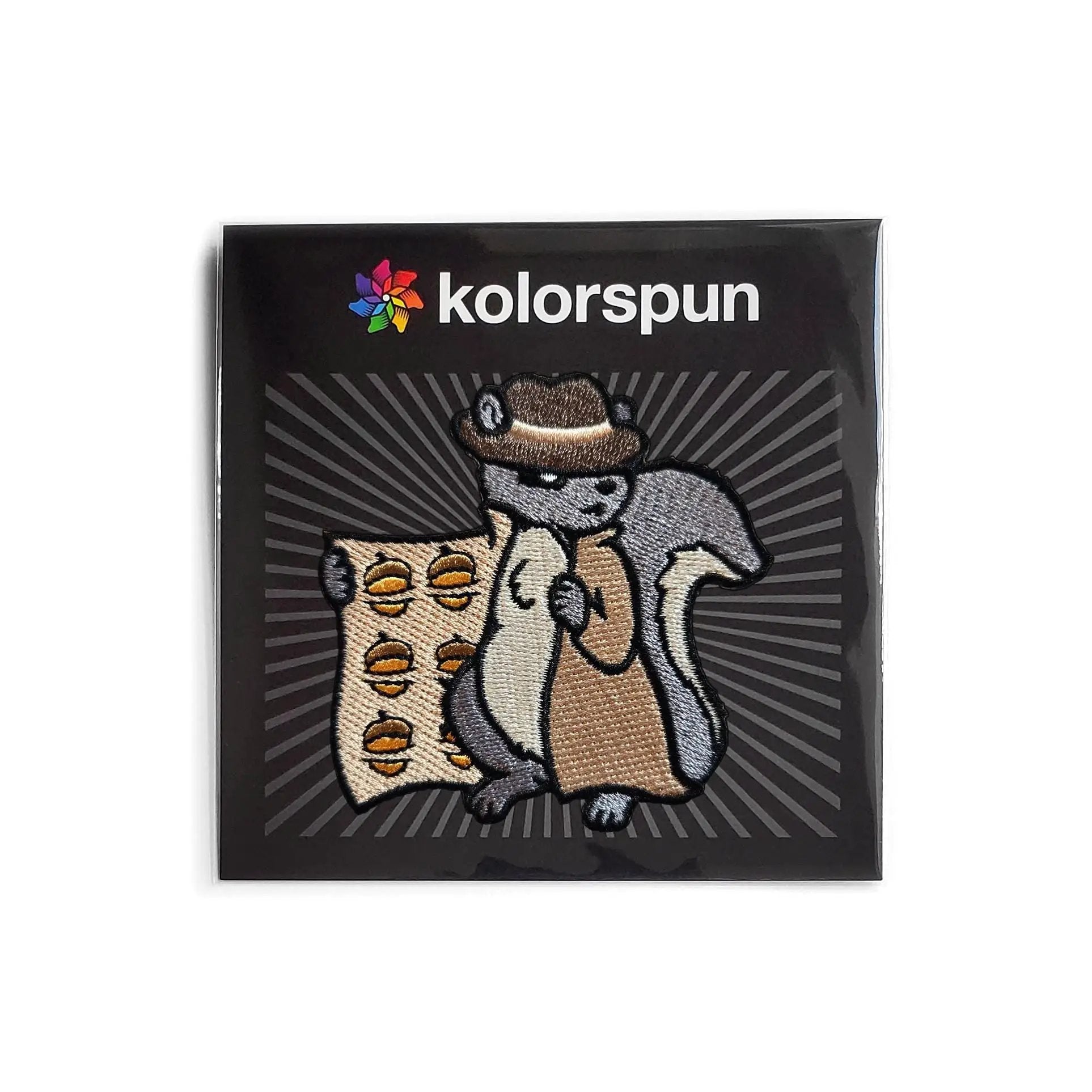 Kolorspun Shady Squirrel patch with colorful embroidered design on fabric background