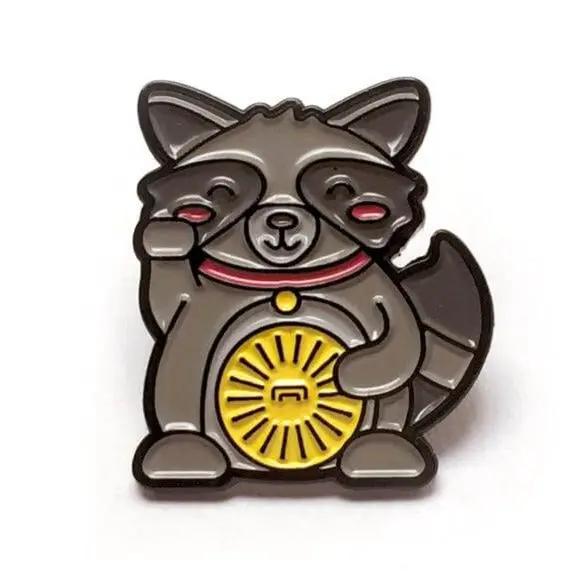 Kolorspun Lucky Raccoon enamel pin featuring a detailed raccoon design on a metal pin back.