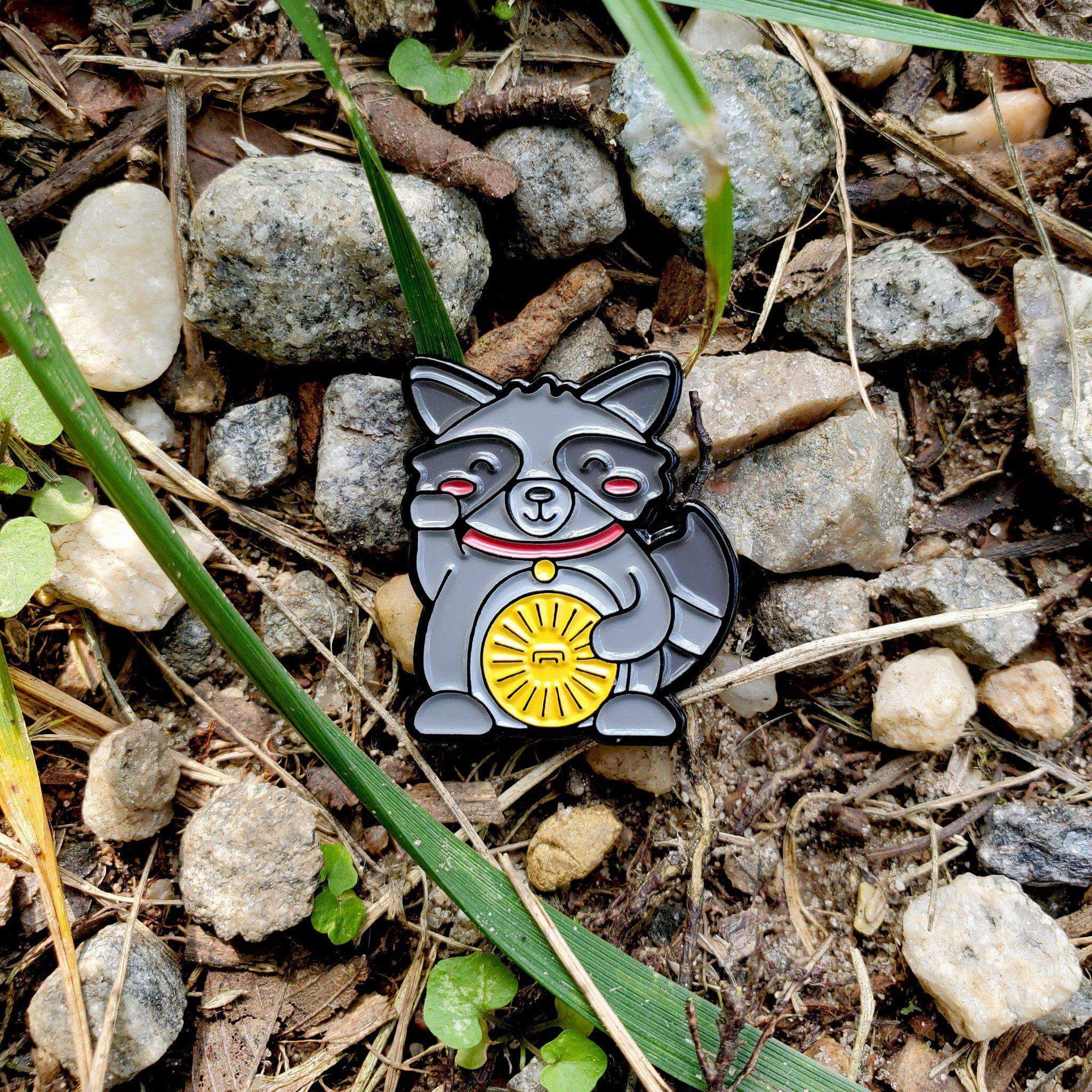 Kolorspun Lucky Raccoon enamel pin featuring a detailed raccoon design on a metal pinback.