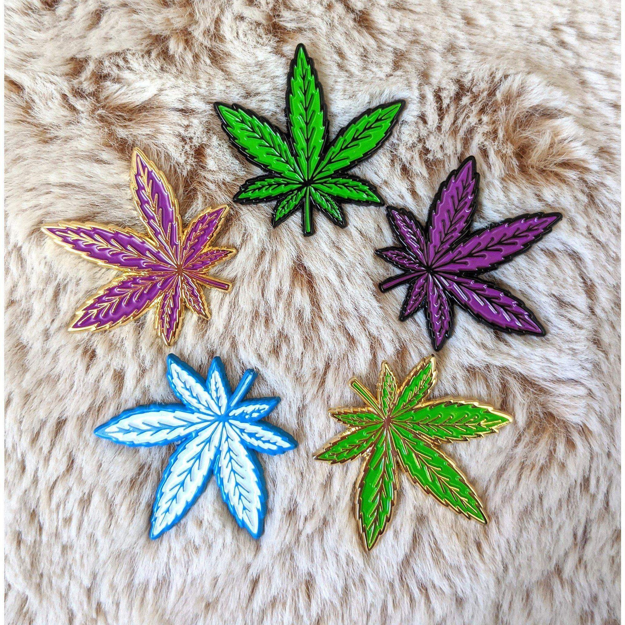 Kolorspun enamel weed leaf pins featuring detailed green leaf design on a metal pin back.
