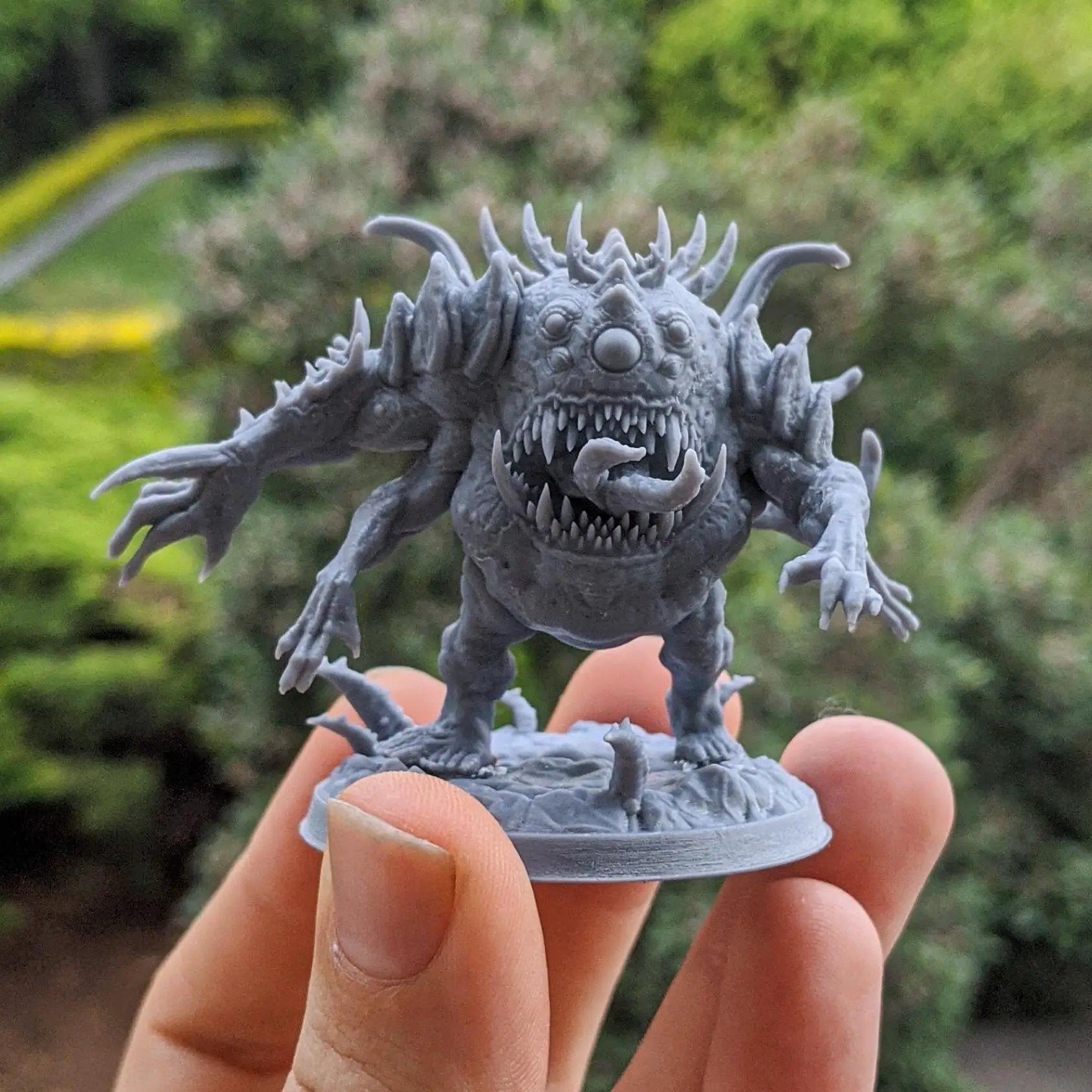 Three 3D printed Abominations miniatures by Dark Gods Miniatures, displayed on a flat surface with detailed textures