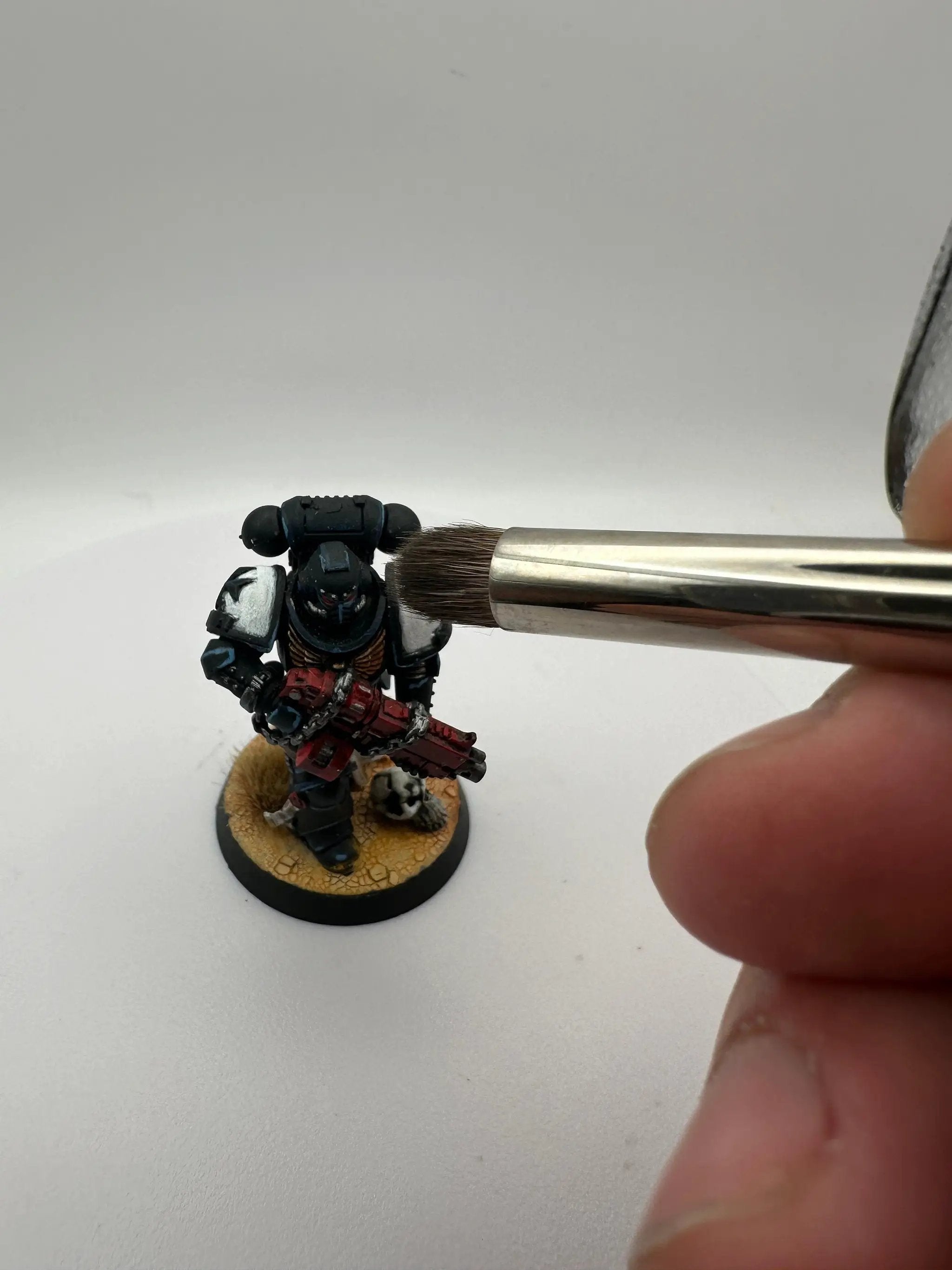Close-up of Last Hope Miniatures small drybrush for miniature painting, showing fine bristles and compact brush head.