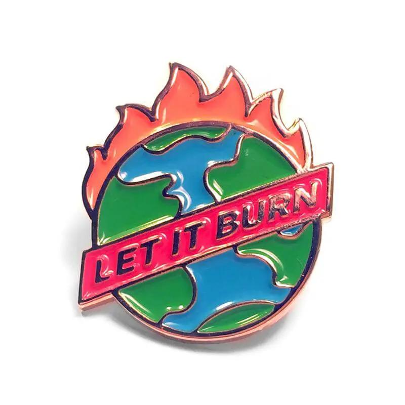 Kolorspun "Let It Burn" enamel pin featuring vibrant flame design and bold lettering on a metal pin backing.