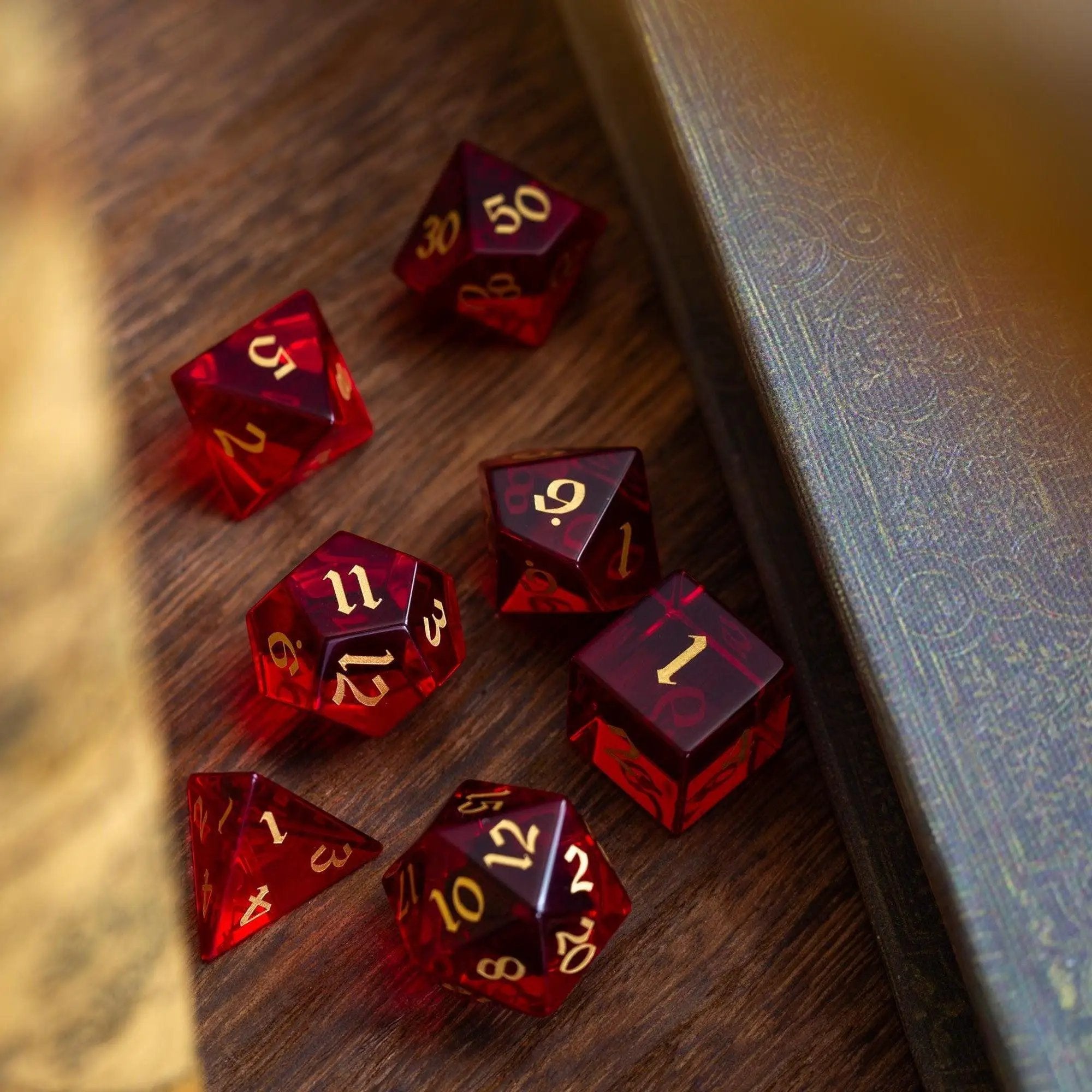 Blood-red hand-carved zircon glass D&D dice set by Runic Dice, featuring gemstone design and intricate craftsmanship.