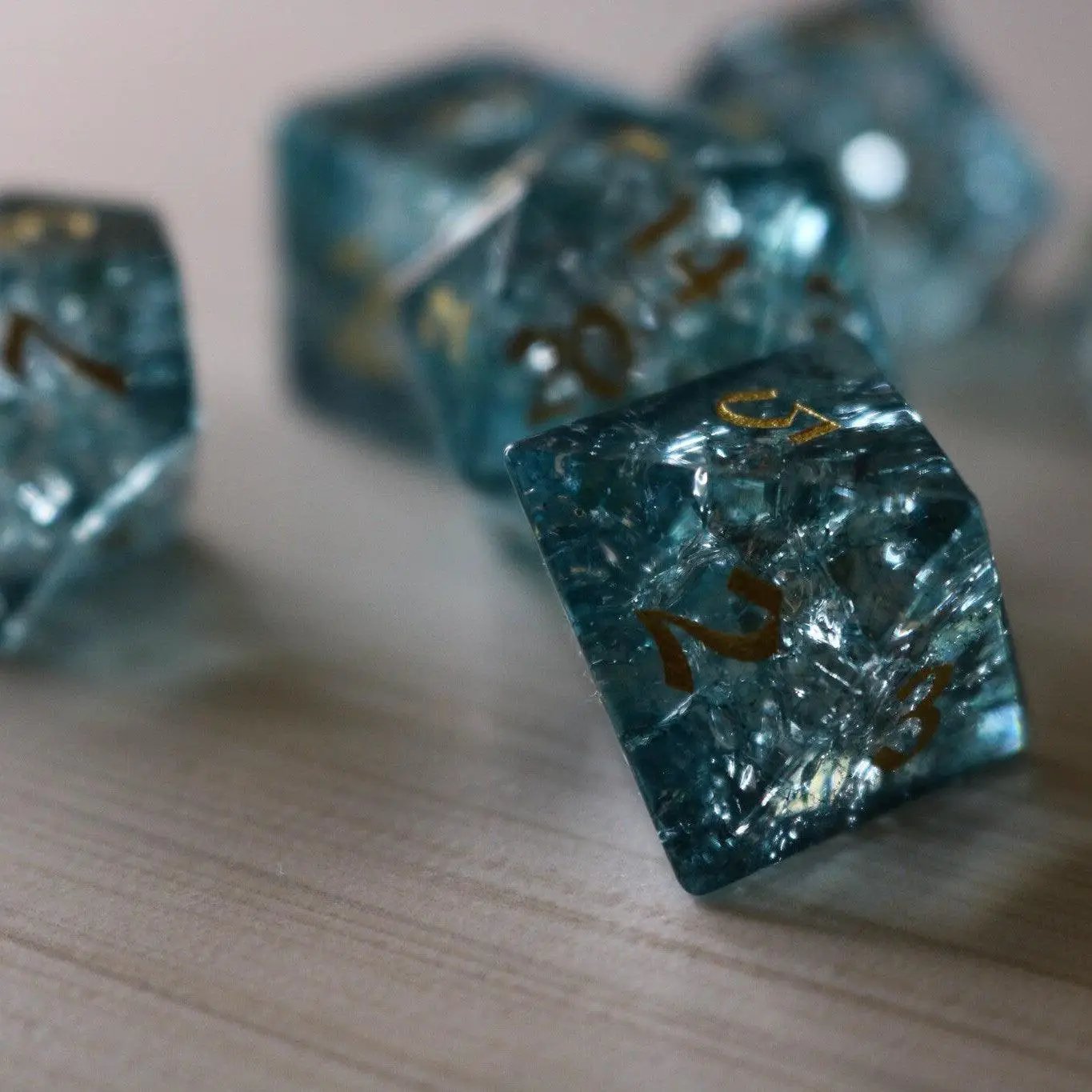 Blue Ocean Forge fire glass gemstone DND dice set by Runic Dice featuring vibrant blue and fiery orange gemstone dice.