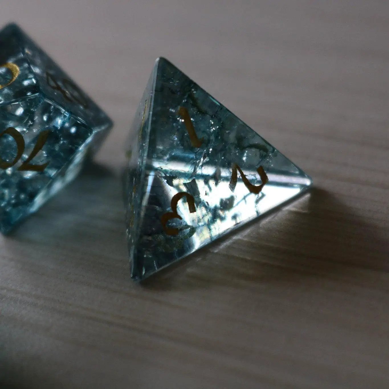 Blue Ocean Forge fire glass gemstone DND dice set by Runic Dice, featuring vibrant blue and orange dice with a fiery design.