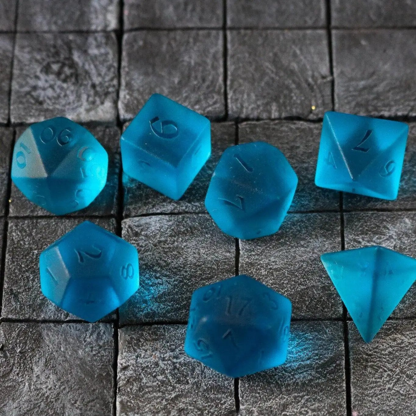 Blue zircon gemstone DND dice set with hand-carved glass design from Runic Dice, featuring vibrant blue color and detailed craftsmanship.