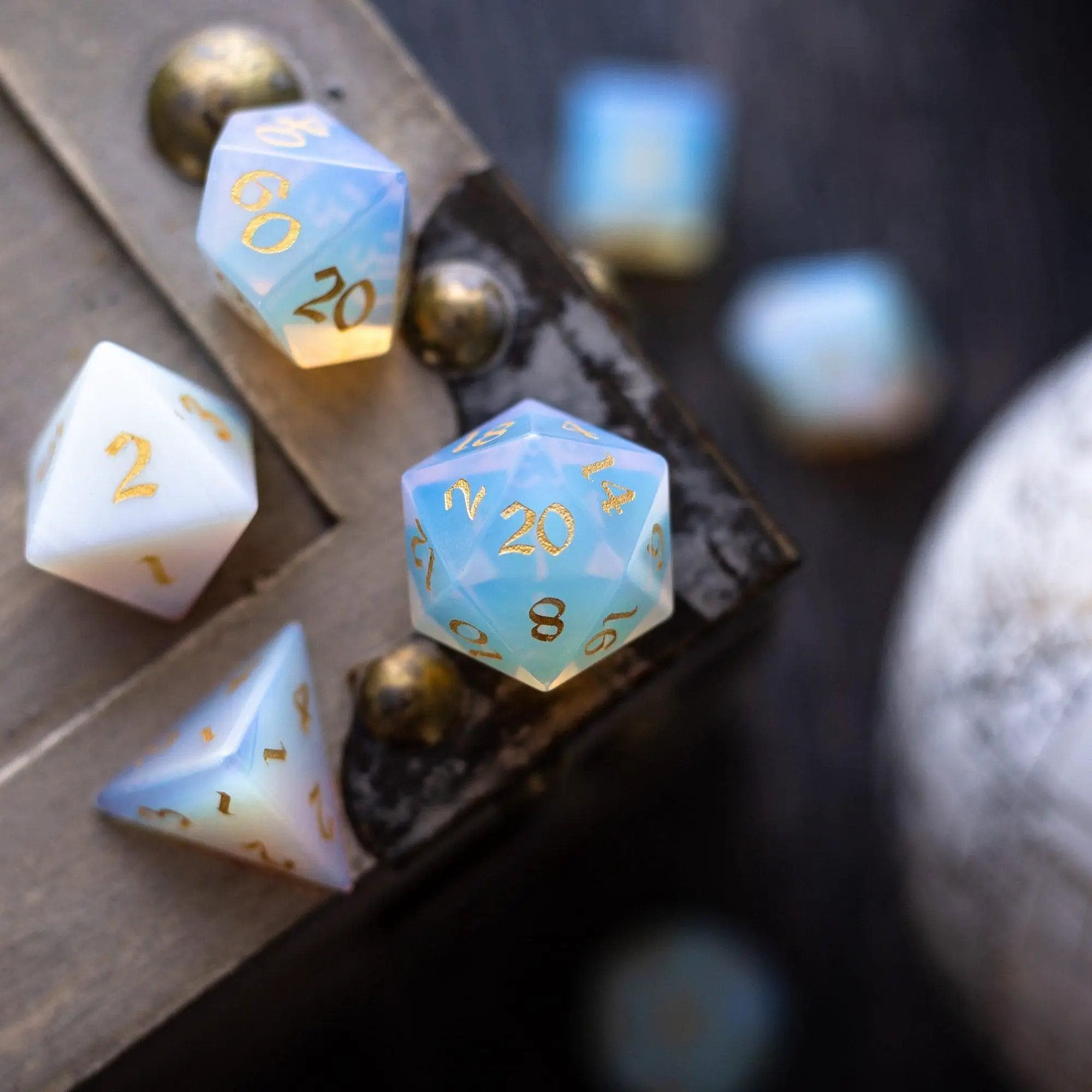 Hand-carved gemstone Opalite DND dice set with gold font from Runic Dice, featuring colorful, polished gemstone dice for tabletop gaming.