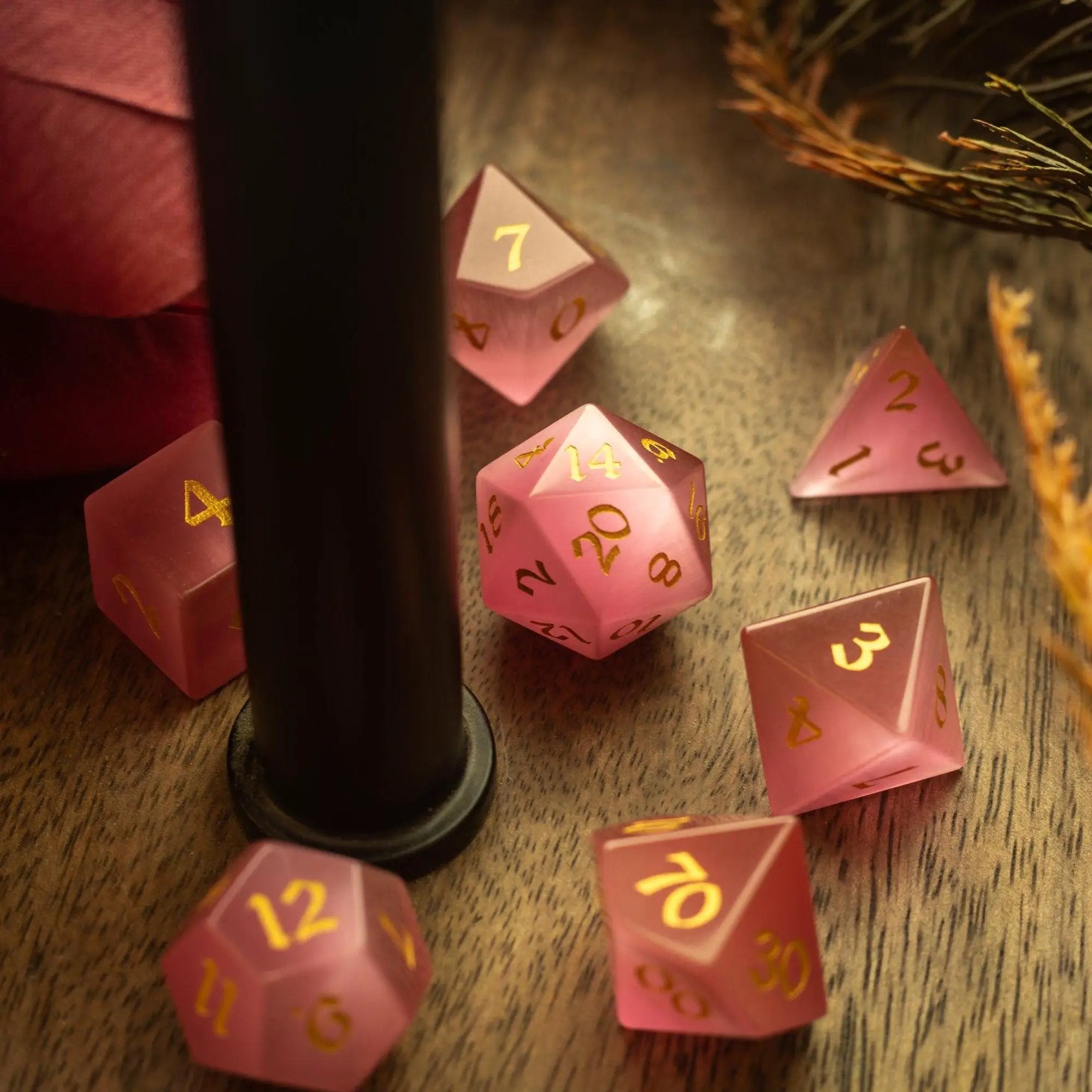 Hand-carved gemstone pink watermelon Cats Eye DND dice set by Runic Dice, featuring vibrant pink and green marble patterns.