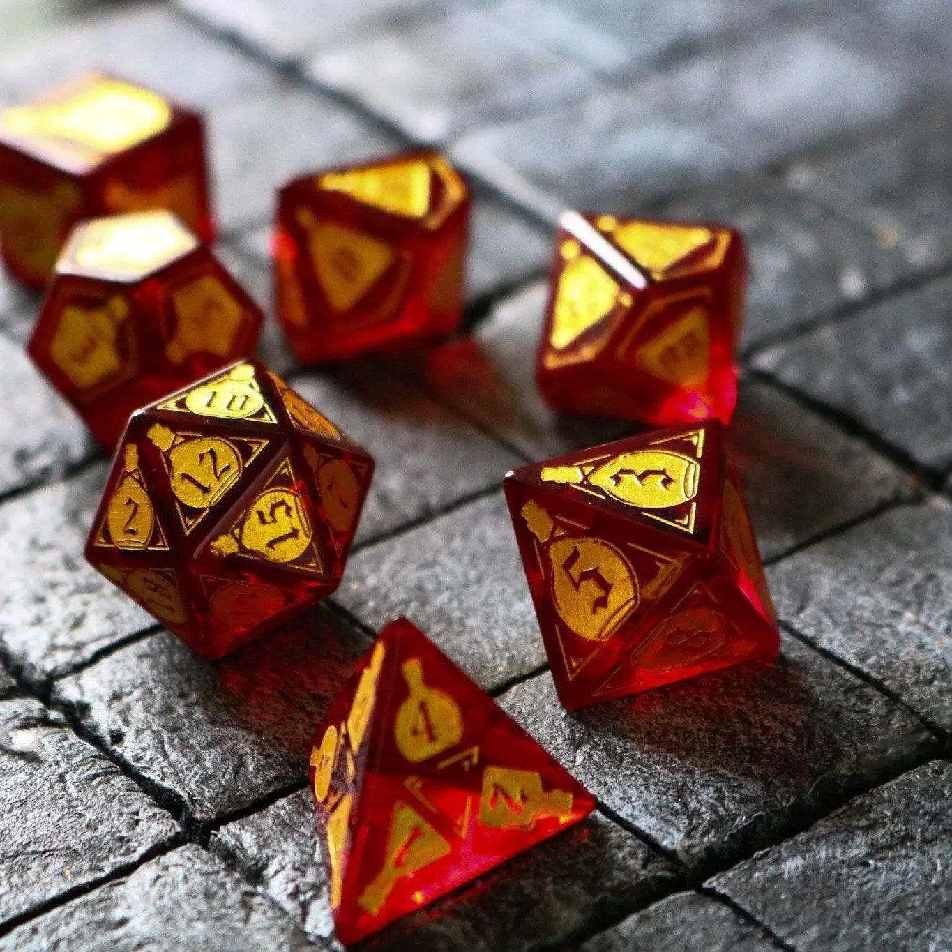 Red zircon gemstone DND dice set by Runic Dice, featuring health potion-themed glass dice for tabletop role-playing games.