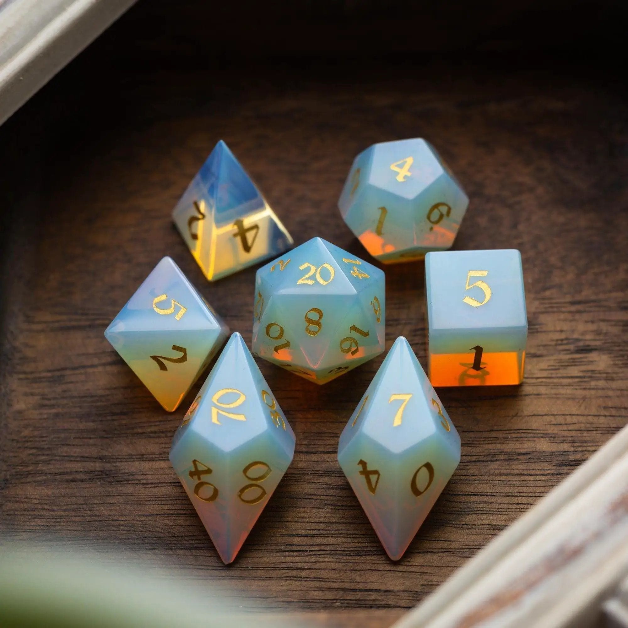 Set of gemstone opalite Elven cut DND dice from Runic Dice featuring intricate gemstone designs and a luminous, mystical appearance.