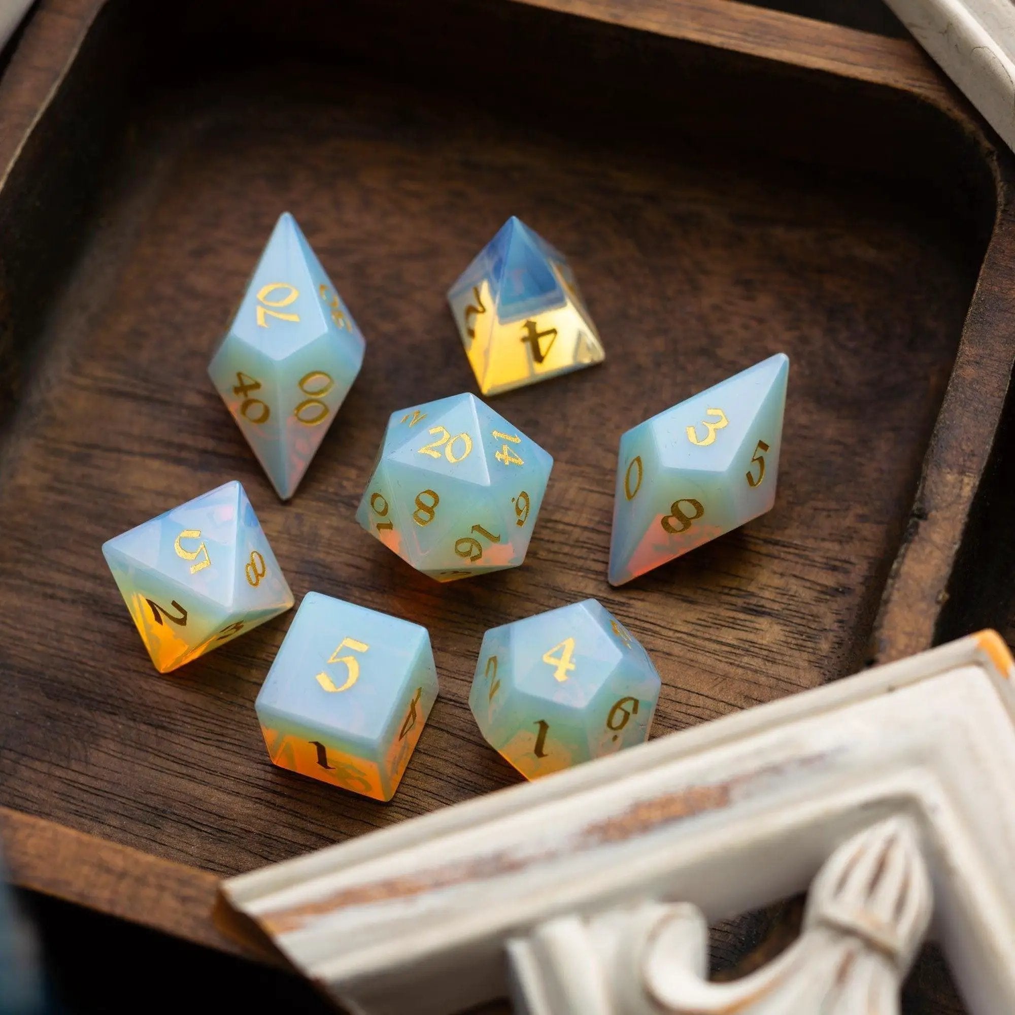 Runic Dice gemstone Opalite Elven cut DND dice set featuring vibrant, translucent gemstone dice with intricate elven-style facets.