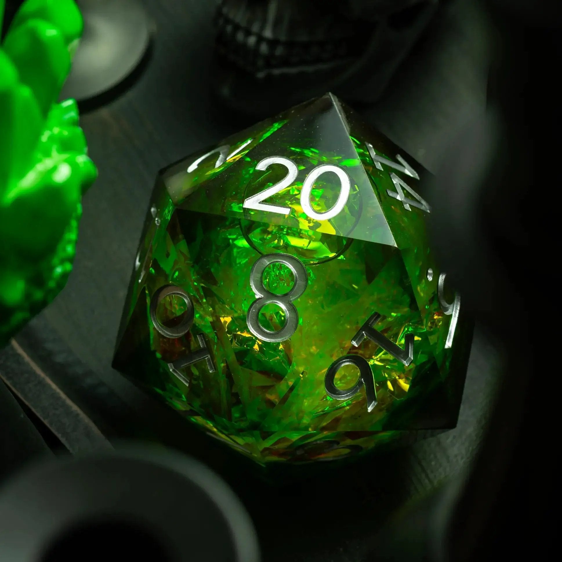 Massive green resin D20 chonk dice with liquid core from Runic Dice, displayed alongside its box.