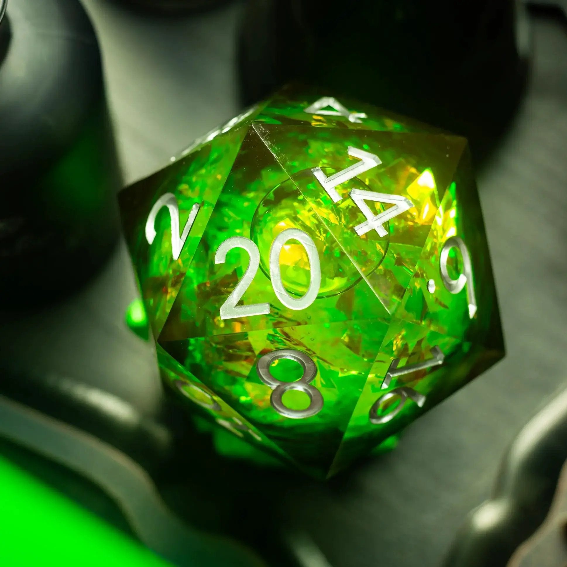 Massive green resin D20 dice with liquid core and chonk size from Runic Dice, displayed with a matching storage box.