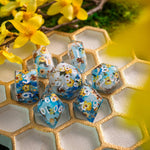 Handmade resin DND dice set by Runic Dice featuring bees and flower designs, perfect for tabletop gaming.