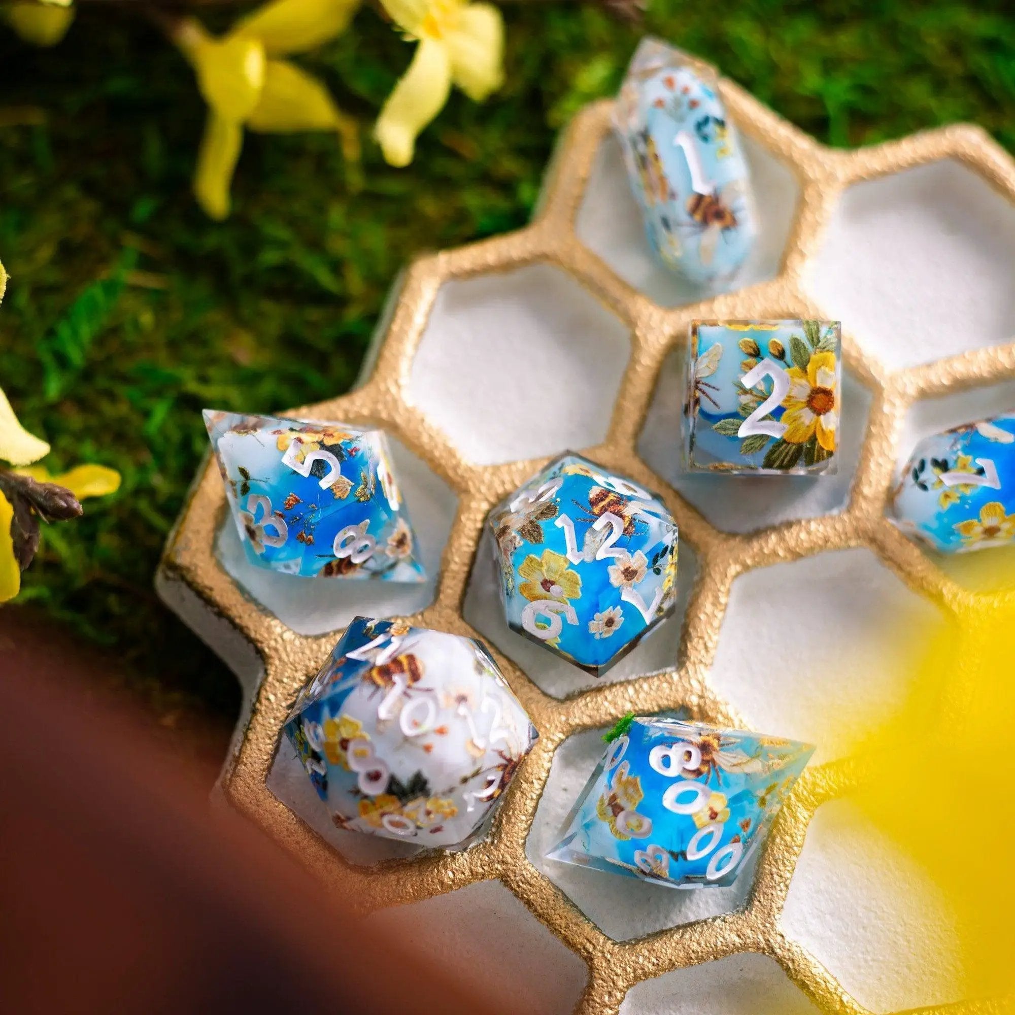 Handmade resin DND dice set with bees and flower design by Runic Dice, featuring detailed bee and floral patterns on each die.