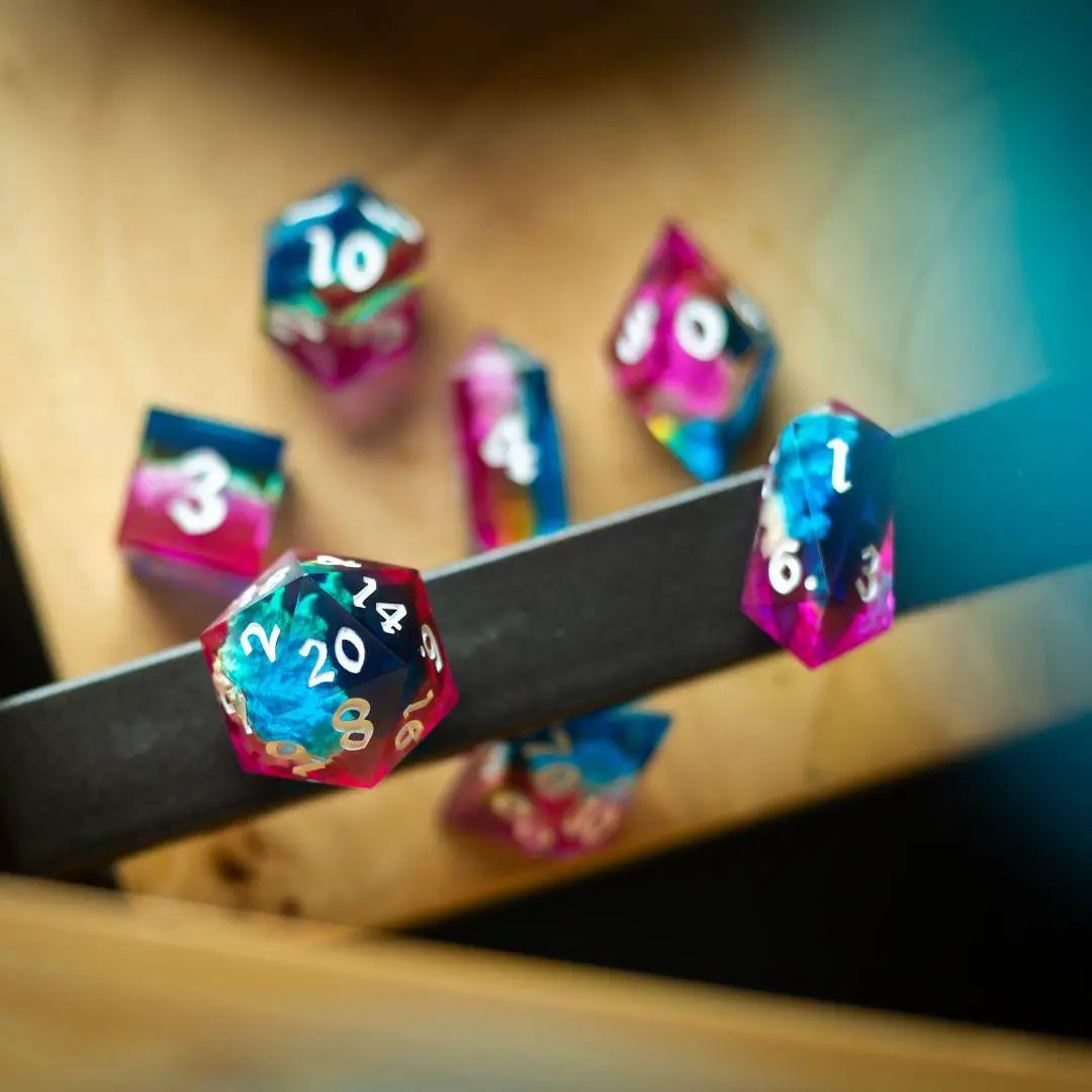 Set of Starlit Rift resin DND dice by Runic Dice featuring cosmic, shimmering designs in various shapes and colors.