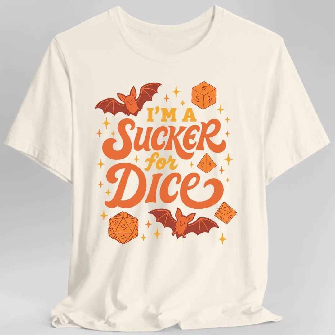 Sunburst RPG "I'm a Sucker for Dice" T-Shirt featuring a playful Halloween-themed D&D design on natural-colored fabric.