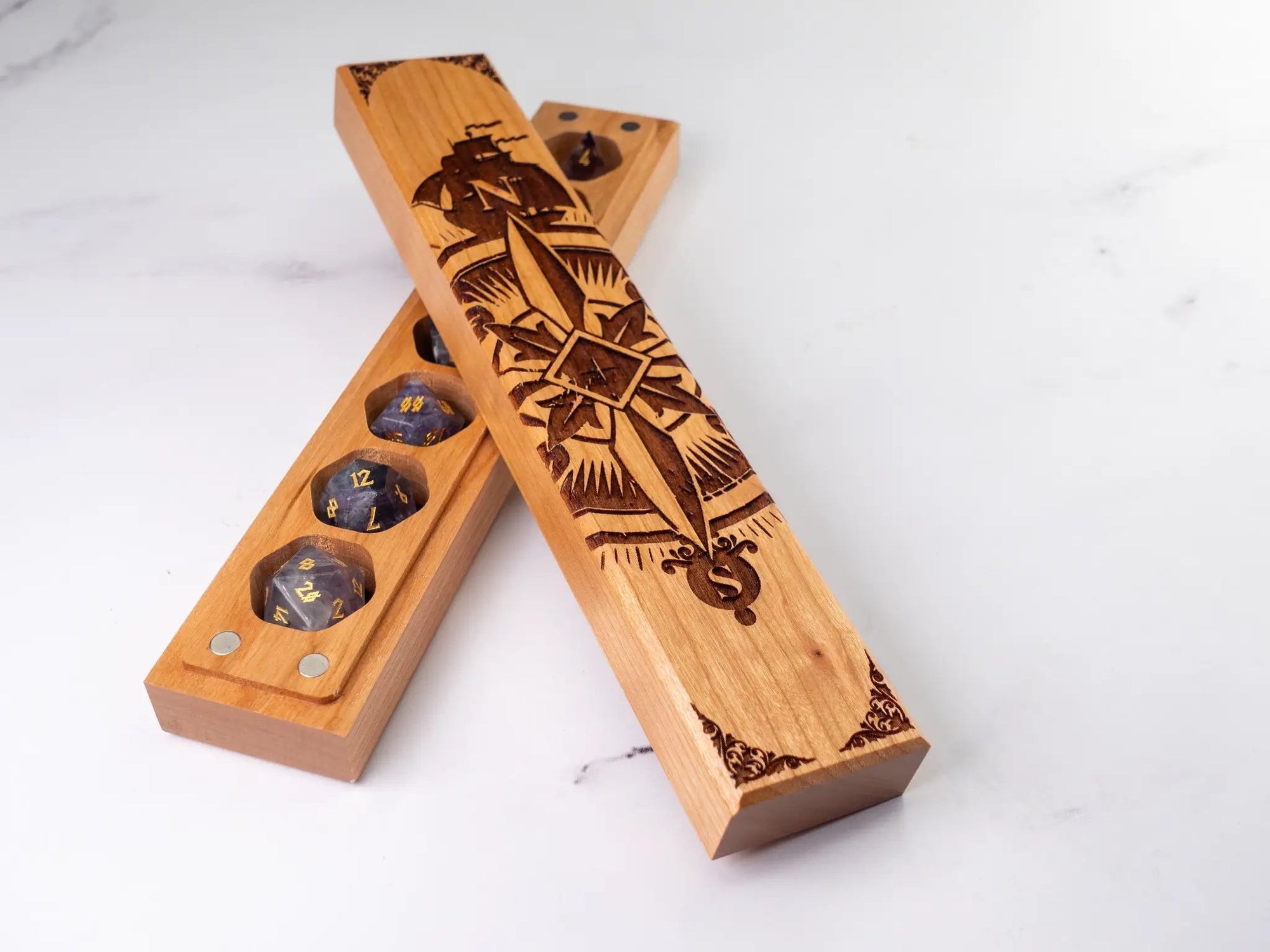 Talon & Claw engraved compass rose dice vault made of aromatic cedar for storing a set of seven dice.