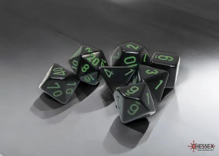 Polyhedral 7-dice set from Chessex with black and green colors, featuring various shapes like d20, d12, and d6.