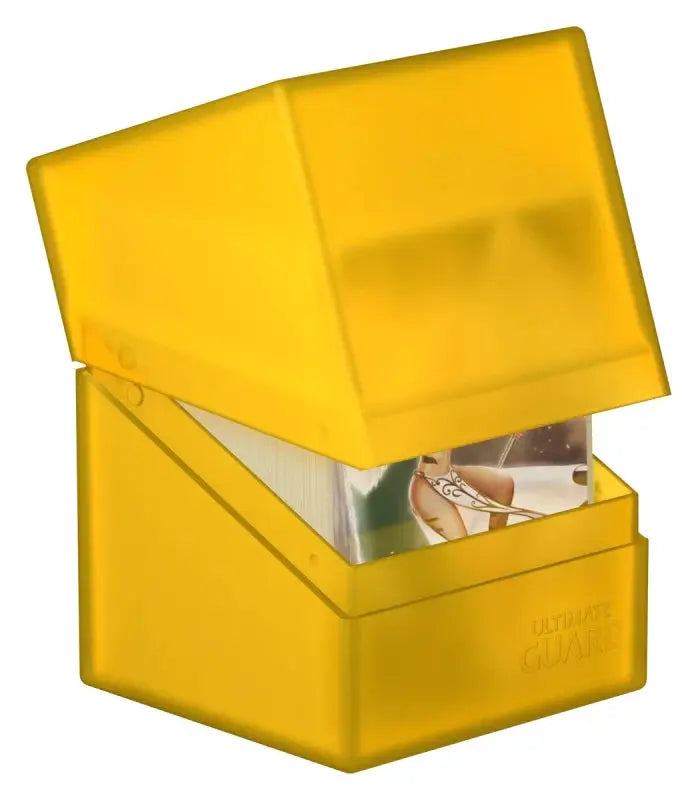Ultimate Guard Boulder 100+ card storage box, transparent black with foam padding for secure collectible card storage.