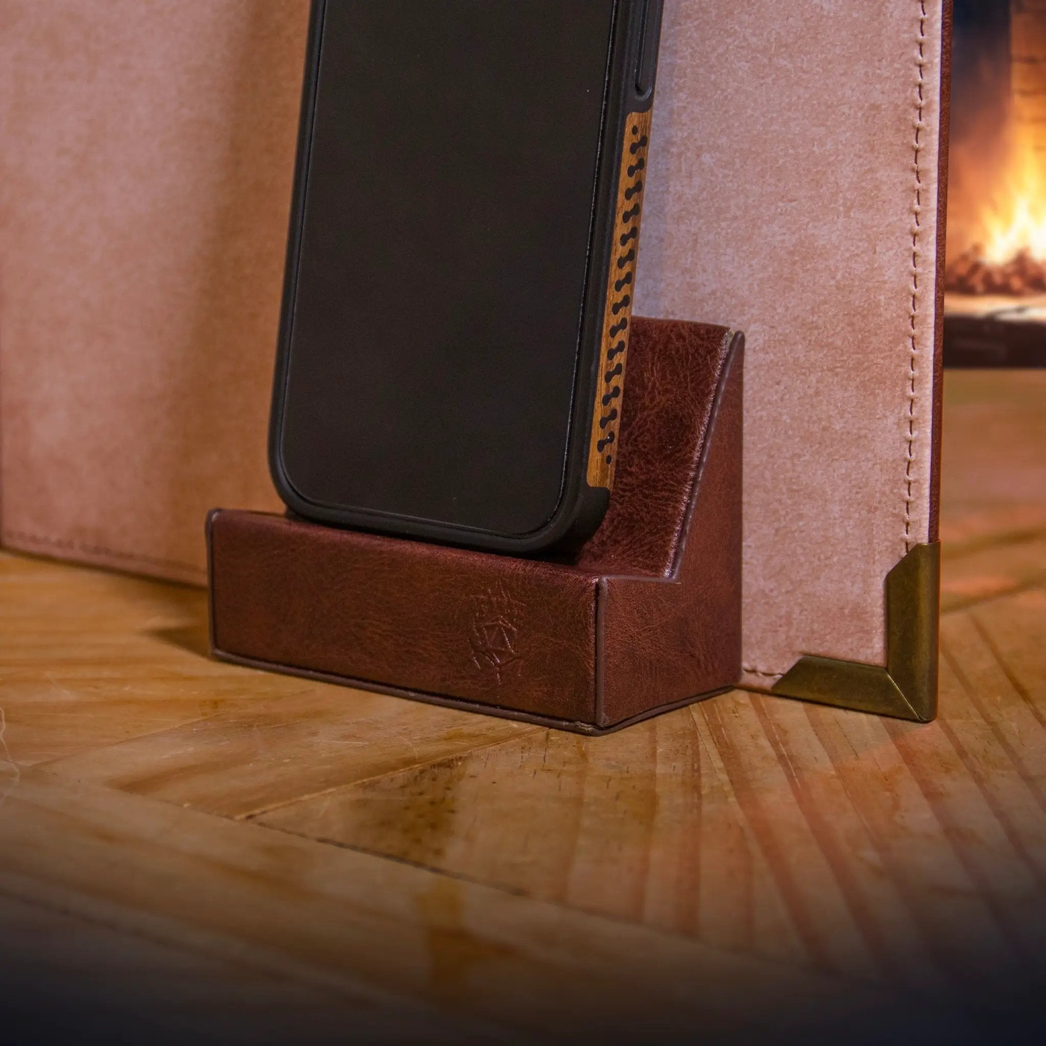 Brown magnetic phone holder by The Ultimate Game Master, designed for digital tools mount on game master screens during TTRPG sessions.