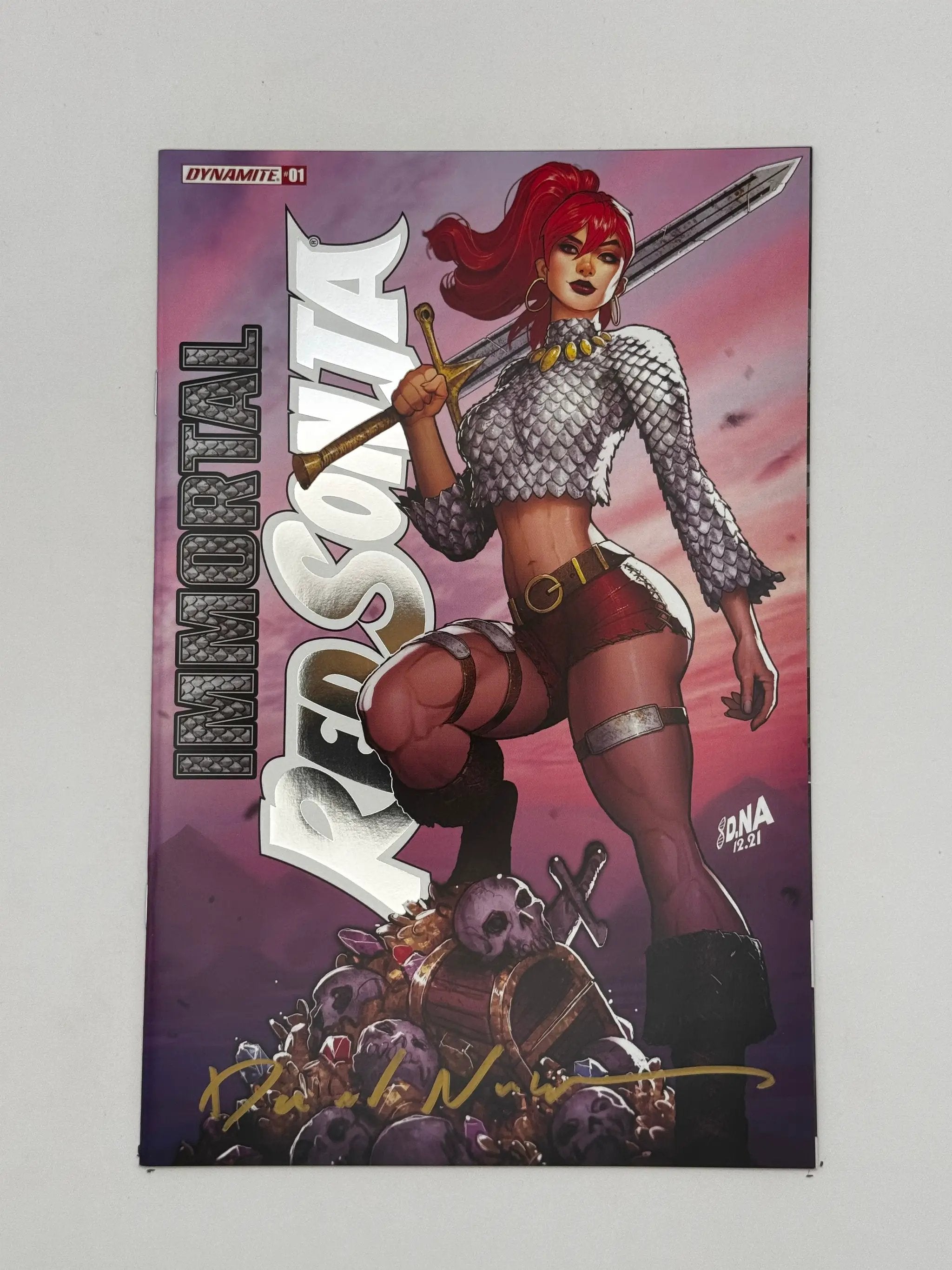 Signed Immortal Red Sonja #1 comic book by David Nakayama with foil stamped logo, featuring vibrant cover art and collectible details.