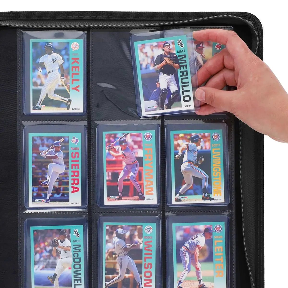 Black Z-Folio 9-Pocket LX album with top-load sleeves, held open with a hand inserting trading cards inside.